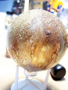 a close up of a doughnut on a stick with some water droplets on it