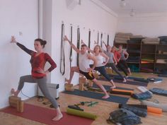 a group of people doing yoga in a room