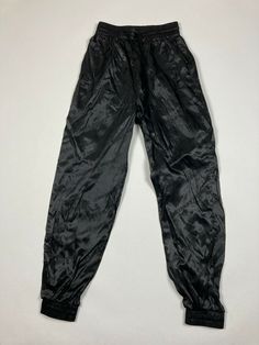 Pants are in great condition. The waist laying flat is 12 inches across laying flat. Top to bottom they are 40.75 inches long. The inseam is 29 inches long. If you have any questions feel free to ask! 90s Style High Waist Black Bottoms, 90s Style Black Pants, 90s Style Fitted Black Pants, Black Grunge Long Pants, 90s Style Full-length Black Pants, Vintage Full-length Black Bottoms, Black Full-length 90s Style Pants, Black Nylon Drawstring Bottoms, Vintage Black Trousers