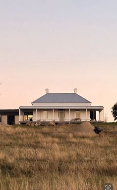 an old farm house sits in the middle of a field