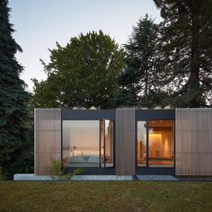 the house is made out of two separate sections, and has glass doors that open to let in natural light