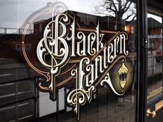 the front window of a restaurant with an ornate sign on it's glass door