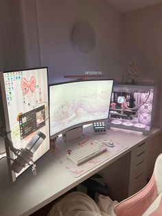 two computer monitors sitting on top of a white desk