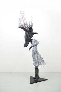 a sculpture of a woman and a horse head