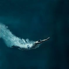 a man swimming in the water with his arms out and head above the water's surface