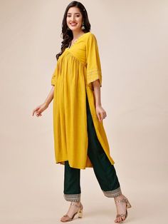 Mustard yellow & green solid kurta with palazzosKurta design:SolidA-line shapePleated styleV-neckThree-quarter flared sleevesGotta patti detailedCalf length with flared hemPure silk machine weave fabricPalazzos design:Embroidered PalazzosPartially elasticated waistbandSlip-on closure Festive Spring V-neck Palazzo Set, Yellow Anarkali Palazzo Set For Spring, Yellow Festive V-neck Sets, Festive Yellow V-neck Set, Traditional Yellow Tunic For Festive Occasions, Spring Anarkali Kurta With V-neck, Festive V-neck Kurta For Spring, Spring Festive V-neck Kurta, Traditional Yellow V-neck Kurta