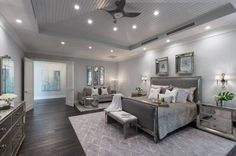 a bedroom with gray furniture and white walls