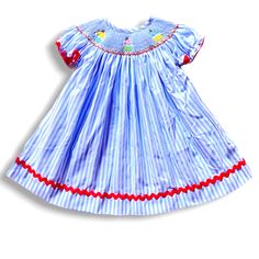 Fabric is cotton woven. Design is embroidered smocking. Dress fits true to size. Cute Smocked Dress For Dress-up, Cotton Smocked Short Sleeve Dress For Daywear, Cotton Short Sleeve Smocked Dress For Daywear, Cotton Smocked Dress For Spring, Spring Embroidered Smocked Dress With Short Sleeves, Casual Cotton Smocked Dress With Smocked Cuffs, Cotton Dresses With Smocked Cuffs And Short Sleeves, Spring Cotton Smocked Dress For Playtime, Cute Daywear Dresses With Smocked Cuffs