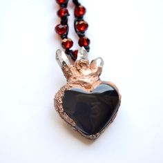 Sacred heart Black onyx and crystal heart necklace Mexican miracle ex vows pendant bohemian jewelry    ... 💖✨ Amulet of love and Protection ✨💖 Onyx Heart Necklace with Quartz Points: At the heart of this jewel, onyx is intertwined with crystal quartz, creating a perfect balance between strength and clarity. The onyx heart symbolizes emotional stability, while the quartz points add a spark of purifying energy.  Protective Miracle: Each necklace carries with it a special miracle, a symbol of love and protection. Carry this little wonder with you, reminding you that you are surrounded by positive energies and constant love. 🌟🔮 Empowerment and Positive Energy: Wear this jewelry to remind yourself how strong and empowered you are. The positive energies of quartz and the stability of onyx wi Nickel-free Black Jewelry For Valentine's Day, Black Nickel-free Jewelry For Valentine's Day, Nickel-free Black Heart-shaped Jewelry, Nickel-free Black Heart Jewelry, Spiritual Black Heart-shaped Necklace, Black Jewelry For Valentine's Day Gift, Black Nickel-free Heart Pendant Jewelry, Nickel Free Spiritual Jewelry For Valentine's Day, Black Spiritual Jewelry For Valentine's Day