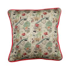 a pillow with red piping on the bottom and a map design on the front