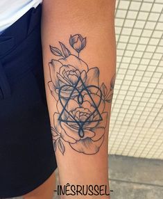 a woman's arm with a rose tattoo on it and the words inferrussel