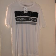 Mk T Shirt Michael Kors Cotton Tops For Spring, Casual Short Sleeve Tops By Michael Kors, Gray Relaxed Fit T-shirt For Fan Merchandise, Casual Short Sleeve Michael Kors Tops, Casual Michael Kors Short Sleeve Tops, Michael Kors Cotton Crew Neck Top, Michael Kors Cotton Short Sleeve Tops, Michael Kors Cotton Top With Logo Print, Michael Kors Cotton Top With Graphic Print