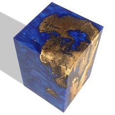 a blue and gold box with an earth map on the inside, in front of a white background