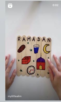 two hands holding up wooden magnets with images of food and drinks on them that spell out rama