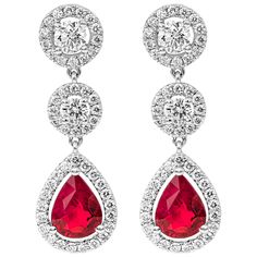 A color-rich pair of dangle earrings showcasing pear shape rubies set in a brilliant diamond halo. Rubies suspended on two diamond halos. Made in 18k white gold. Rubies weigh 2.25 carats total; diamonds weigh 1.13 carats total. Roman Malakov is a custom house, specializing in creating anything you can imagine. If you would like to receive a special quote on a custom piece please message or call us. Fancy Earrings, Diamond Dangle Earrings, Red Diamond, Expensive Jewelry, Ear Rings, Pear Diamond, Women Diamond, Pear Shaped Diamond, Diamond Drops