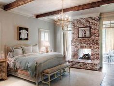 a bedroom with a brick fireplace and bed