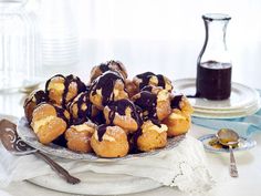 a plate full of donuts with chocolate drizzled on them