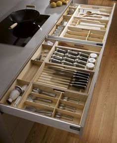 an organized kitchen drawer is shown with utensils and other items in the drawers