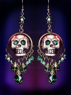 "These Dangly Crystal Gothic Skull Chandelier Earrings are made with sparkling crystal beads and hand-painted skulls with rhinestone eyes. The painted dripping blood and antiquing makes this pair super scary! Love these for an everyday Gothic or Dark style. They're fun to wear and make a statement. Available with Posts, Clip-Ons or French Wires. -3 1/2\" Long x 1\" Wide -0.4 oz. ea. Metal Finishes Available: -Bronze -Silver Colors Available: -Black Cat -Witchy Purple -Spooky Green -Blood Red *Co Halloween Fantasy Dangle Jewelry, Fantasy Halloween Dangle Jewelry, Mystical Dangle Jewelry For Halloween, Bohemian Halloween Party Jewelry, Bohemian Jewelry For Halloween Party, Nickel-free Skull Jewelry For Party, Green Halloween Party Jewelry, Halloween Skull-shaped Jewelry For Jewelry Making, Halloween Skull Jewelry For Jewelry Making