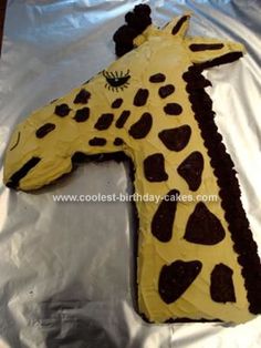 a cake shaped like a giraffe on top of foil