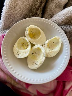 an open hard boiled egg on a white plate