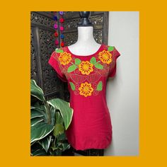 "A very nice and beautiful Sunflower Blouse w/Gorgeous Embroidery. The design work is simply gorgeous. Perfect for your ultimate weekend look, beach, casual look or just to impress your friends with this gorgeous piece. You will Love it! Blouse STYLE DETAILS Overview * Round neck * Handmade work * 3/4 Long sleeves * 22\" UNDERARM TO UNDERARM, 30.5\" SHOULDER TO HEM fabric & care * hand wash * delicate care * hang dry Please email me your questions before buying email me TODAY All of my items Fitted Embroidered Beach Top, Fitted Top With Multicolor Embroidery For Vacation, Fitted Tops With Multicolor Embroidery For Vacation, Fitted Multicolor Embroidered Top For Vacation, Red Cotton Blouse With Embroidered Neckline, Short Sleeve Tops With Motif For Summer, Traditional Floral Print Summer Top, Casual Tops With Multicolor Embroidery And Motif, Fitted Multicolor Embroidered Top For Beach