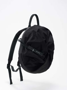 The unique ADRIA makes for a mesmerizing backpack with a variety of ways it can be worn. Whether on the back, carried by hand, or fixed to a luggage handle the backpack is a stunning spatial wonder. The main compartment with its padded device pocket accommodates laptops of up to 13”. An additional front pocket can be accessed by opening the twisted front and closed by using the drawstring fixed to it. Modern Nylon Standard Backpack, Modern Nylon Duffle Bag With Removable Pouch, Nylon Travel Backpack With Removable Pouch, Modern Laptop Backpack For Trips, Nylon Backpack Travel Bag, Nylon Backpack With Detachable Strap For Commuting, Functional Nylon Backpack With Detachable Strap, Modern Travel Backpack For Trips, Modern Nylon Backpack Travel Bag