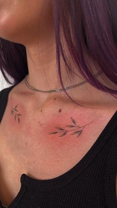 a woman with purple hair and tattoos on her chest