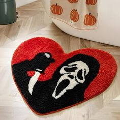 a heart shaped door mat with an image of a woman holding a knife on it