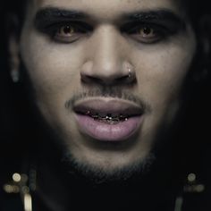 a man with piercings on his face and nose