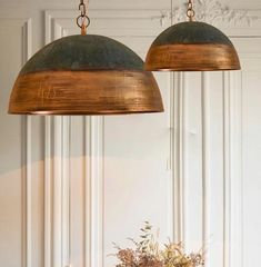 two lamps hanging from the ceiling over a table