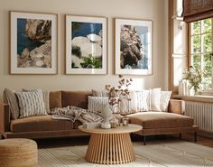 a living room filled with furniture and pictures hanging on the wall above a coffee table