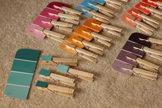 several clothes pins laid out on the floor next to each other with colored strips sticking out of them