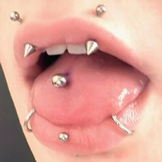 a close up of a person with metal studs on their mouth and tongue,