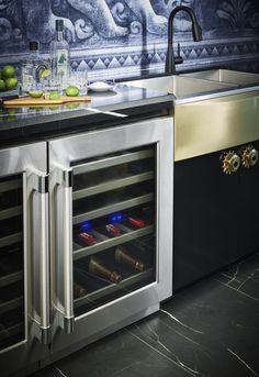 an open wine cooler in the middle of a kitchen