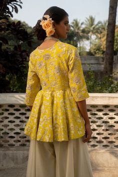 Yellow three fourth sleeves V neck flared peplum style kurti with all over vintage bloom print and zardozi hand embroidered highlights. Paired with an ivory flared palazzo pant. - Aza Fashions Fitted Peplum Tops For Festive Occasions, Fitted Peplum Top For Festive Season, Festive Fitted Top With Set-in Sleeves, Wedding Palazzo Set With Resham Embroidery And Peplum Top, Wedding Peplum Palazzo Set With Resham Embroidery, Eid Semi-stitched Peplum Palazzo Set, Semi-stitched Resham Embroidered Palazzo Set For Festivals, Festive Fitted Peplum Top, Fitted Resham Embroidery Palazzo Peplum Set