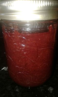 a red jar sitting on top of a counter