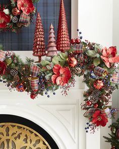 christmas wreaths and decorations hanging on the fireplace