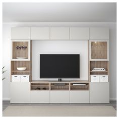 a flat screen tv sitting on top of a wooden entertainment center