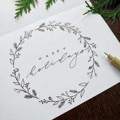 a handwritten happy birthday card on top of a piece of paper next to evergreen branches