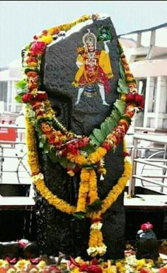 the statue is decorated with flowers and garlands