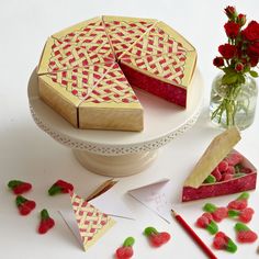 there is a cake on the table with raspberries next to it and flowers