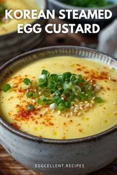 two bowls filled with egg custard and garnished with chopped green onions