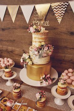 a table topped with lots of cakes and cupcakes