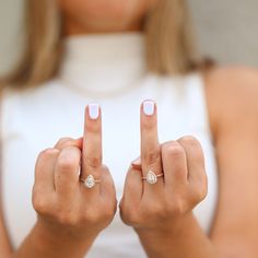 a woman holding two fingers up in the air