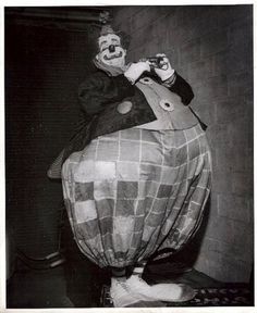 an old photo of a clown on top of a hot air balloon in the shape of a man