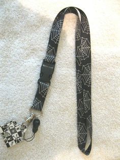 a black and white spider web camera strap