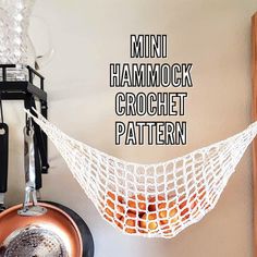 there is a hammock hanging from the wall next to a pot and pan