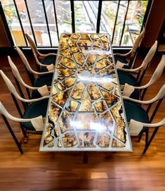 a long table with chairs around it in front of a window that has an image of food on it