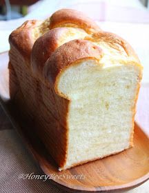 a loaf of bread sitting on top of a wooden plate